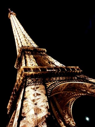 Looking up the Eiffel Tower at night